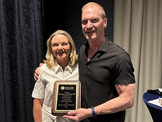 Academy Secretary for State Affairs John D. Peters, MD, recognizes and thanks Secretariat regional member Kimberly Crowder, MD, during the Secretariat's July 18-20 meeting in Milwaukee.